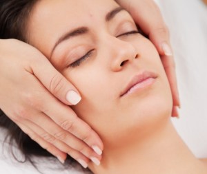 Acupuncture needles on head of a young woman at the spa